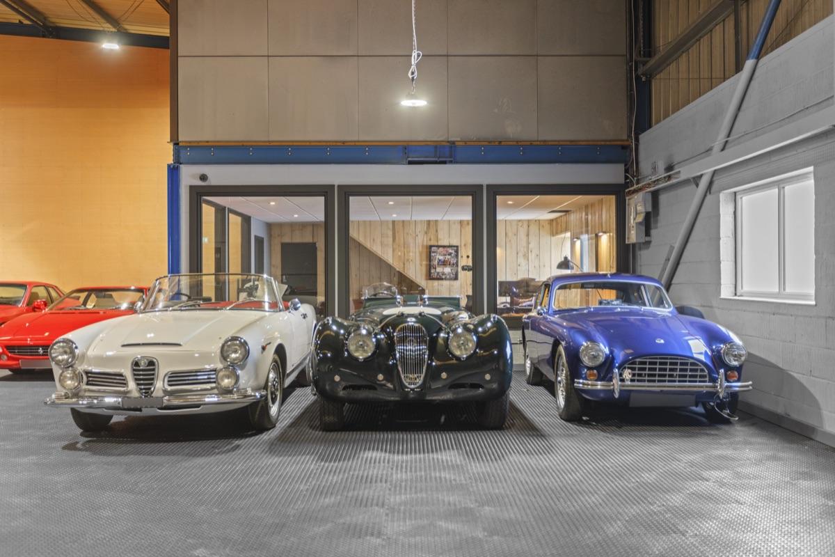 Premium indoor car storage facility with luxury vehicles in allocated bays