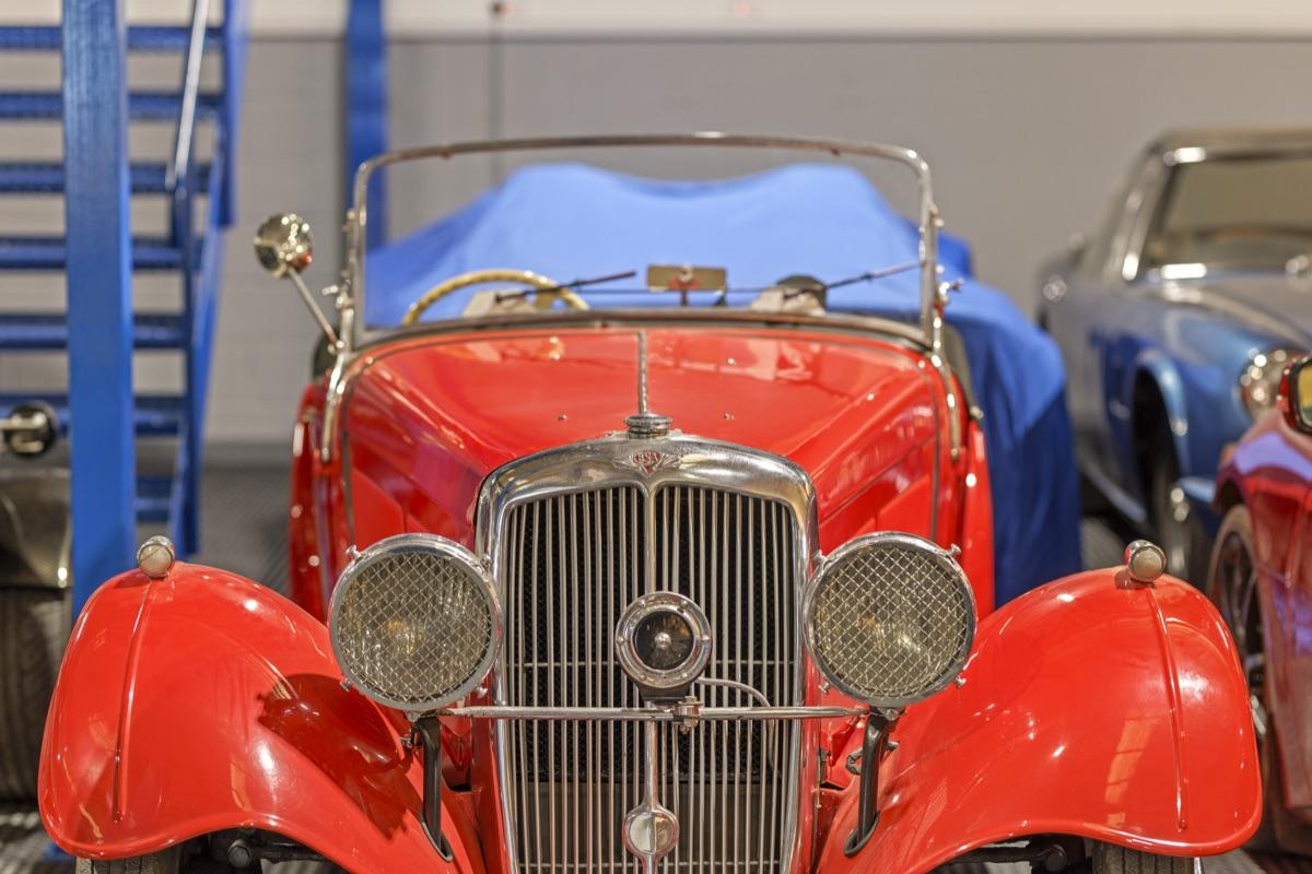 Classic red vintage roadster in storage