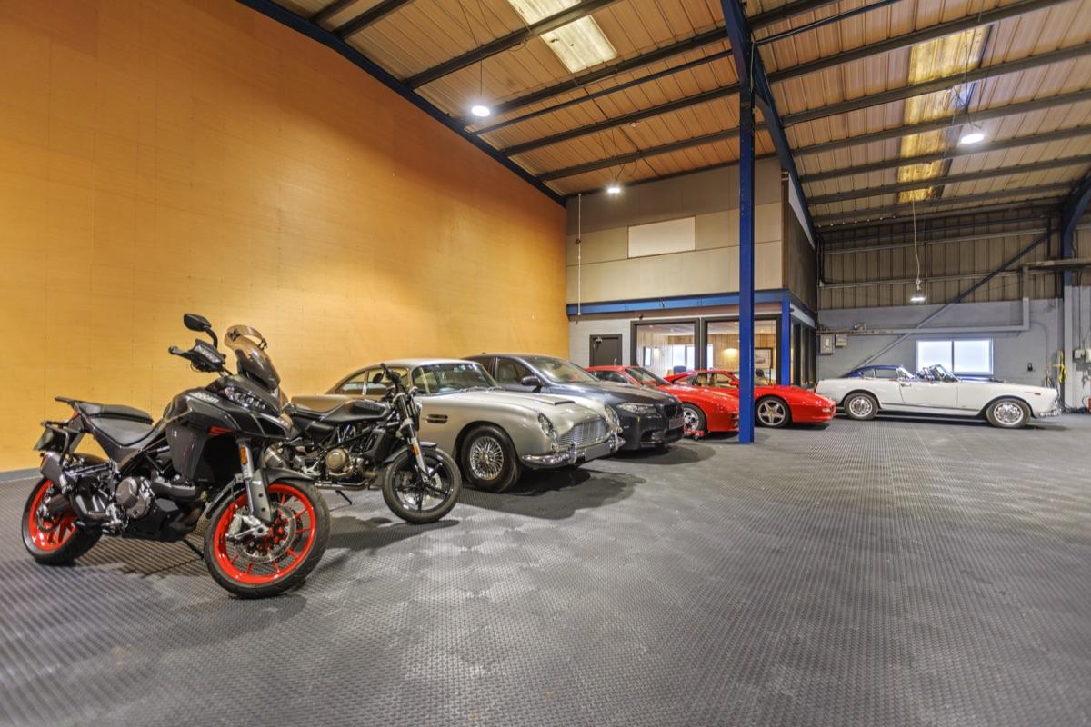Motorcycles stored securely alongside classic cars