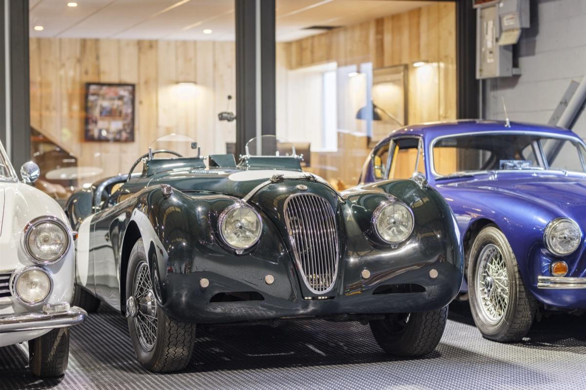 Vintage Jaguar XK120 alongside classic AC Bristol